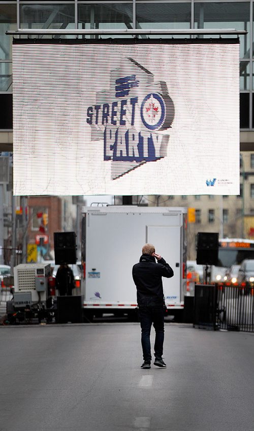 PHIL HOSSACK / WINNIPEG FREE PRESS - STREET PARTY - Giant screens play to a party of one as the city's downtown streets are closed off in preparation for the Jets Whiteout Party Tuesday.   Jessica's story.  - May 1, 2018