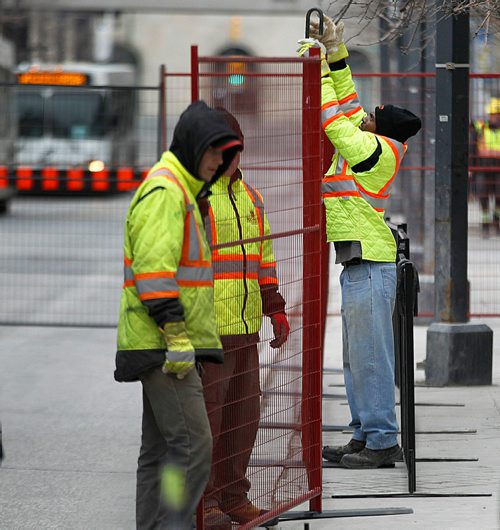 PHIL HOSSACK / WINNIPEG FREE PRESS - STREET PARTY - Workers assemble fences that close off the Graham street bus mall to pedestrian traffic only.  Jessica's story.  - May 1, 2018