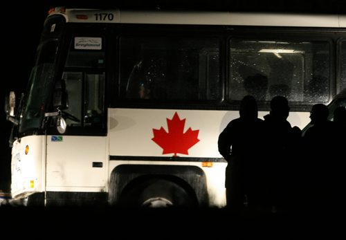 Brandon Sun Vince Li sits in a Greyhound bus as police surround the vehicle after the Edmonton man stabbed and dismembered a fellow passenger in July. (Colin Corneau/Brandon Sun)