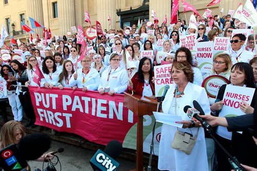 BORIS MINKEVICH / WINNIPEG FREE PRESS
Around 700 nurses and supporters converged on to the steps of the Manitoba Legislature today to protest against healthcare cuts. President of the 12,000 member Manitoba Nurses Union Sandi Mowat, right at the mic, speaks at the event. JANE GERSTER STORY.  May 2, 2018