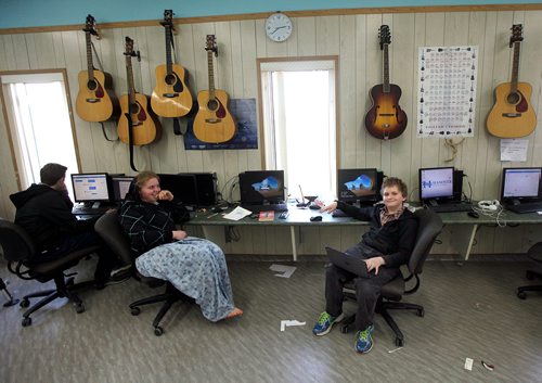 PHIL HOSSACK / WINNIPEG FREE PRESS - Orlando Maendel (right) laptop on his knee works in the Crystal Springs computer equiped school Wednesday.  Bill Redekop's story.  - May 2, 2018