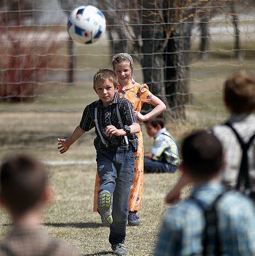 PHIL HOSSACK / WINNIPEG FREE PRESS - Elementary school kids on the Crystal Springs Hutterite Colony enjoy recess and Bill Redekop's story.  - May 2, 2018