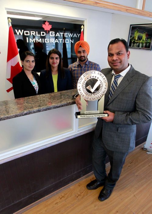 BORIS MINKEVICH / WINNIPEG FREE PRESS
From left, Navdeep Kaur, Istpreet Kaur, Bhavjot Singh, and Zora Singh Kainth pose for a photo at Kainth's business called World Gateway Immigration at 787 McPhillips Street. The three behind Kainth are employees there. Kainth holds an award that the company has won. CAROL SANDERS STORY.  May 4, 2018