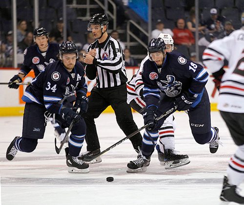 PHIL HOSSACK / WINNIPEG FREE PRESS - Manitoba Moose #34 JC Lipon and #18 Brody Sutter race for the puck Friday evening at the Bell MTS Place.  - May 4, 2018