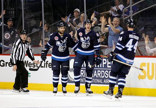 PHIL HOSSACK / WINNIPEG FREE PRESS - Manitoba Moose Captain Patrice Comier (left) and #10 Buddy Robinson celebrate Robinson's opening goal against the Rockford Icehogs with #44 Julian Melchiori Friday evening at the Bell MTS Place.  - May 4, 2018