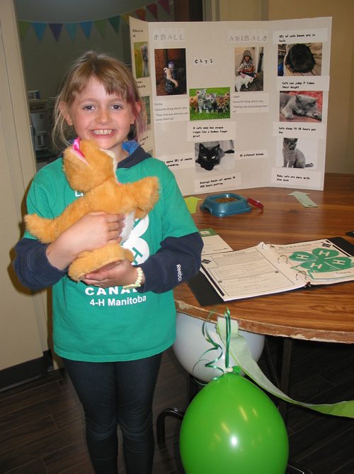 Canstar Community News April 28 - La Salle 4-H Club member Emma Hedge explored her love of cats for her project at the club's achievement on April 28. (ANDREA GEARY/CANSTAR COMMUNITY NEWS)