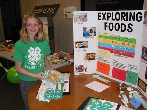 Canstar Community News April 28 - La Salle 4-H Club member Morgan Lippens displays the granola bars she made as part of her Explore Foods project shown at the club's achievement on April 28. (ANDREA GEARY/CANSTAR COMMUNITY NEWS)