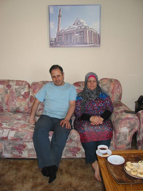 Canstar Community News April 23, 2018 - Kasem Al Hallaq and Iftikar Al Houlani sit beneath a picture of a mosque in Homs, Syria where the family formerly lived. )ANDREA GEARY/CANSTAR COMMUNITY NEWS)