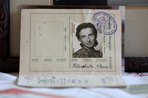 RUTH BONNEVILLE / WINNIPEG FREE PRESS

Passages feature on Olena Hryn.
Photo of her at age 26yrs in her passport from 1948. 
Olena Hryn witnessed some of the most harrowing ordeals of the 20th century. 
Olena survived both the Soviet and Nazi occupations of her Ukrainian homeland, the Holodomor and the break-up of her family. Her father was a cleric forced into hiding. Her mother had to leave her in the care of relatives the worst winter of the famine--- in order to avoid being dragooned into Russian brigands that raided Ukrainian farms for their grain stores.
After the Second World War she as a refugee in a displaced persons camp. The Allies opened up local universities to  refugees and  Olena was finishing up her medical degree at a German university when she suddenly got a shot to come to Canada.

Her daughter, Mariika Hryn, sets out photos and memorabilia on table in her St. Vital home.   

See Alex Paul story

May 10,  2018
