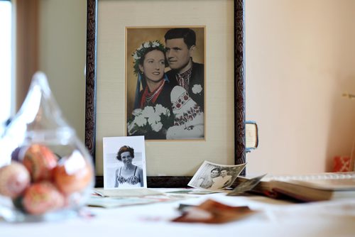 RUTH BONNEVILLE / WINNIPEG FREE PRESS

Passages feature on Olena Hryn.
Photo of a photo of Olena (30yrs), and her husband Nicholas Hryn. 

Olena Hryn witnessed some of the most harrowing ordeals of the 20th century. 
Olena survived both the Soviet and Nazi occupations of her Ukrainian homeland, the Holodomor and the break-up of her family. Her father was a cleric forced into hiding. Her mother had to leave her in the care of relatives the worst winter of the famine--- in order to avoid being dragooned into Russian brigands that raided Ukrainian farms for their grain stores.
After the Second World War she as a refugee in a displaced persons camp. The Allies opened up local universities to  refugees and  Olena was finishing up her medical degree at a German university when she suddenly got a shot to come to Canada.

Her daughter, Mariika Hryn, sets out photos and memorabilia on table in her St. Vital home.   

See Alex Paul story

May 10,  2018
