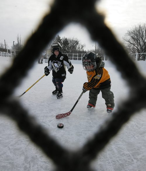 Brandon Sun Dexter Beyette, 4, lines up his shot at the net as he and Andrew Neary, 4, play a little outdoor hockey at the West End Community Centre on Thursday afternoon. (Bruce Bumstead/Brandon Sun)