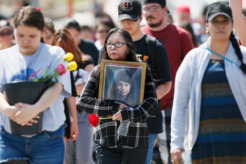 JOHN WOODS / WINNIPEG FREE PRESS
Joyce Nepinak carries a photo of her daughter Tanya, who went missing 7 years ago, as she walks in the 14th annual Mother's Day Memorial Walk in downtown Winnipeg Sunday, May 13, 2018. Family, friends and supporters walked to honour missing and murdered loved ones.
