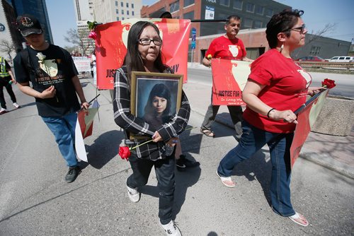 JOHN WOODS / WINNIPEG FREE PRESS
Joyce Nepinak carries a photo of her daughter Tanya, who went missing 7 years ago, as she and family members of Serena McKay walk in the 14th annual Mother's Day Memorial Walk in downtown Winnipeg Sunday, May 13, 2018. Family, friends and supporters walked to honour missing and murdered loved ones.