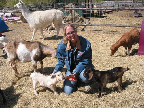 Canstar Community News May 9, 2018 - Judy Thenevot, who operates Six Pines Petting Farm in theRM of Rosser with husband James, is shown with two of this season's baby goats. (ANDREA GEARY/CANSTAR COMMUNITY NEWS)