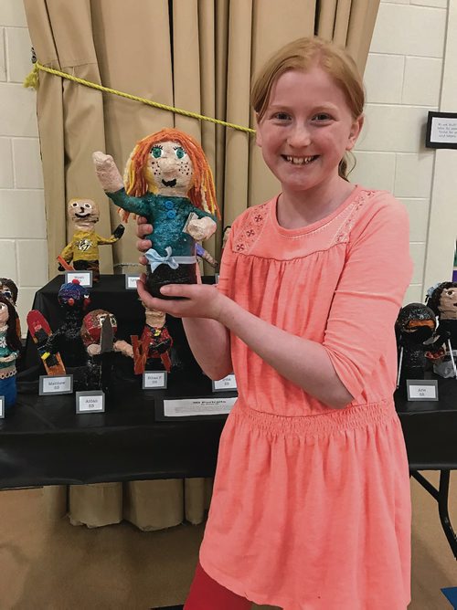 Canstar Community News Lydia-Jane, a Grade 5 student at Calvin Christian School, shows off a 'mini-me' sculpture she made in art class using papier-mache, plaster, and paint. (SHELDON BIRNIE/CANSTAR/THE HERALD)