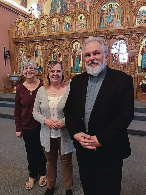 Canstar Community News (From left) Longtime Holy Eucharist parishioner Elaine Bowman, Holy Eucharist Parish office manager and longtime parishioner Carlene Deptuch, and Father Michael Kwaitkowski are excited to celebrate the parish's 100th anniversary with parishioners and the community at large. (SHELDON BIRNIE/CANSTAR/THE HERALD)