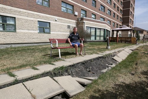 MIKE DEAL / WINNIPEG FREE PRESS
Tom Ellis outside the co-op seniors home at 404 Desalaberry, Columbus House. The riverbank has had erosion issues and just a couple of weeks ago the sidewalk collapsed now the riverbank is 15 feet away from the building.
180515 - Tuesday, May 15, 2018.