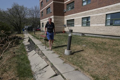 MIKE DEAL / WINNIPEG FREE PRESS
Tom Ellis outside the co-op seniors home at 404 Desalaberry, Columbus House. The riverbank has had erosion issues and just a couple of weeks ago the sidewalk collapsed now the riverbank is 15 feet away from the building.
180515 - Tuesday, May 15, 2018.