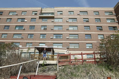 MIKE DEAL / WINNIPEG FREE PRESS
Tom Ellis outside the co-op seniors home at 404 Desalaberry, Columbus House. The riverbank has had erosion issues and just a couple of weeks ago the sidewalk collapsed now the riverbank is 15 feet away from the building.
180515 - Tuesday, May 15, 2018.