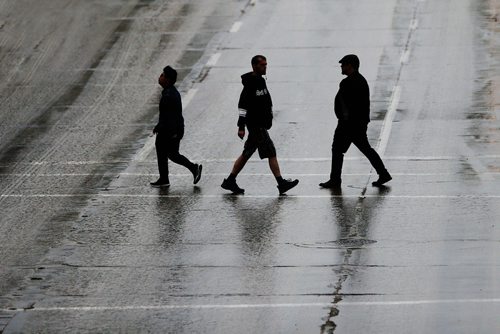 JOHN WOODS / WINNIPEG FREE PRESS
Pedestrians cross a wet Portage Avenue as rain falls Tuesday, May 15, 2018