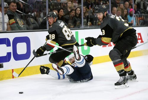 TREVOR HAGAN / WINNIPEG FREE PRESS
Winnipeg Jets' Bryan Little (18) falls between Vegas Golden Knights' Nate Schmidt (88) and Brayden McNabb (3) during game 3 of the Western Conference Finals in Las Vegas, Wednesday, May 16, 2018.