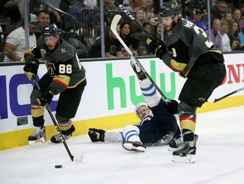 TREVOR HAGAN / WINNIPEG FREE PRESS
Winnipeg Jets' Bryan Little (18) falls between Vegas Golden Knights' Nate Schmidt (88) and Brayden McNabb (3) during game 3 of the Western Conference Finals in Las Vegas, Wednesday, May 16, 2018.