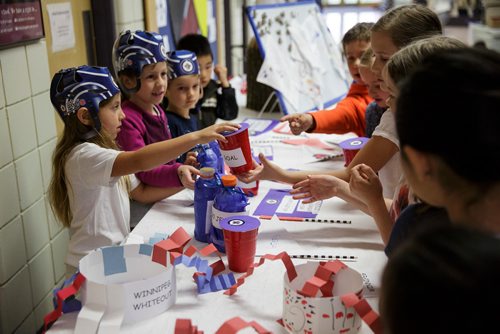 MIKE DEAL / WINNIPEG FREE PRESS
Kindergarten students at Island Lakes School made a bunch of Jets cheer gear and are giving the items to other students who bring in food for Winnipeg Harvest Friday morning.  
180518 - Friday, May 18, 2018.