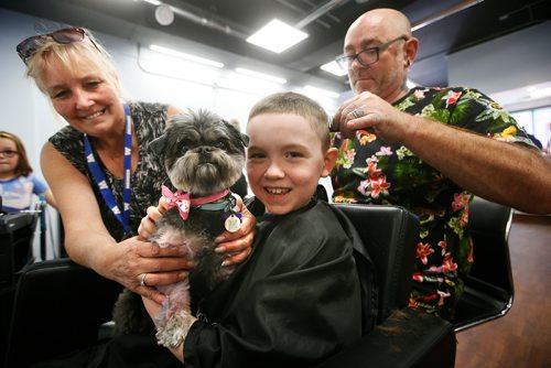JOHN WOODS / WINNIPEG FREE PRESS
Rylan Hordeski, 8, holds 2 year old Boo with Cathie Mieyette, founder/director of Spirit Of Hope Rescue as Zane Kirk, a stylist at Urban Crush Salon, cuts his hair during a 24 hour Cut-a-Thon in support of Spirit Of Hope Rescue at Urban Crush Salon Saturday, May 19, 2018. The event hopes to raise $5000 for the dog rescue.