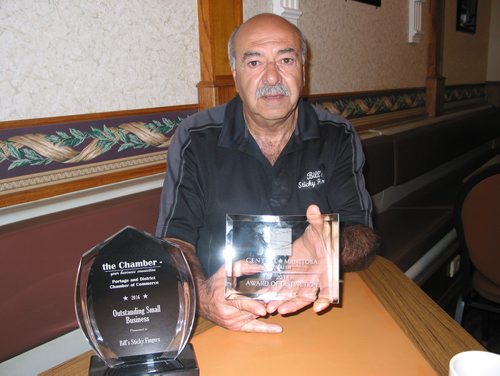 Canstar Community News May 14, 2018 - Bill Protopapas, owner of Bill's Sticky Fingers at 210 Saskatchewan Ave. E in Portage la Prairie, displays the award he recently won from Central Manitoba Tourism along with another he received from the Portage la Prairie & District Chamber of Commerce in 2016. (ANDREA GEARY/CANSTAR COMMUNITY NEWS)