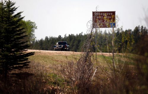 PHIL HOSSACK / WINNIPEG FREE PRESS - A boater travels past signs indicating the upcoming Pinegrove Rest Stop Tuesday afternoon as a steady stream of traffic pulled in to use the facilities. Pinegrove is popular with truckers due to easy access and egress for the large tractor trailers. - MAY 17, 2018.