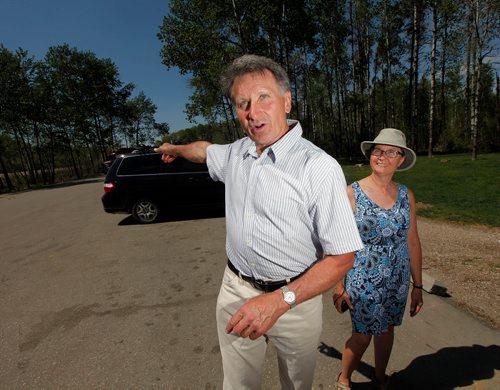 PHIL HOSSACK / WINNIPEG FREE PRESS - Wayne Lovenuk gestures to a transport truck pulling into the Pinegrove Rest Stop parking lot Tuesday afternoon as a steady stream of traffic pulled in to use the facilities.  His wife Penny (right).  - MAY 17, 2018.