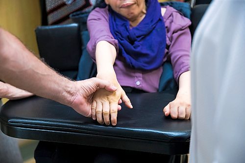 MIKAELA MACKENZIE / WINNIPEG FREE PRESS
Resident Cathy Romeo holds her brother Joe Romeo's hand in the newly renovated St. Amant living space in Winnipeg on Wednesday, May 23, 2018.  
Mikaela MacKenzie / Winnipeg Free Press 2018.