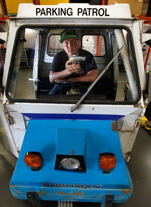 PHIL HOSSACK / WINNIPEG FREE PRESS - Grade 11 MITT automotive services student Mathieu Hrynchuk poses with a Cushman Truckster students are restoring at the trade school. The vehicles were originally used by "Meter Maids" by the city, and later parking commissionaires. See Bill Redekop's story. - May24, 2018