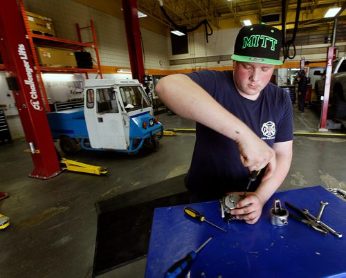 PHIL HOSSACK / WINNIPEG FREE PRESS - Grade 11 MITT automotive services student Mathieu Hrynchuk pulls apart the carburetor from a Cushman Truckster students are restoring at the trade school. The vehicles were originally used by "Meter Maids" by the city, and later parking commissionaires. See Bill Redekop's story. - May 24, 2018