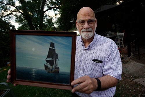 PHIL HOSSACK / WINNIPEG FREE PRESS - Sam Richards sailed on the Nonsuch in the 1970's. He poses in his back yard with a favorite painting of the small tall ship sailing into Hudson's Bay. See Jill Wilson's story. - MAY 24, 2018.