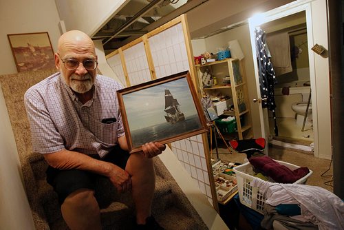 PHIL HOSSACK / WINNIPEG FREE PRESS - Sam Richards sailed on the Nonsuch in the 1970's. He poses in his basement with a favorite painting of the small tall ship sailing into Hudson's Bay. He also sailed on the "Golden Hind", Sir Francis Drake's ship,  which is pictured in a photograph behind him. See Jill Wilson's story. - MAY 24, 2018.