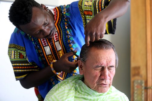 TREVOR HAGAN /  WINNIPEG FREE PRESS
John Baffour cuts hair for Milton McKeever, 76, earlier today. End Homelessness Winnipeg and the Manitoba Financial Empowerment Network put on a homelessness expo at the Neeginan Centre, Saturday, May 26, 2018.