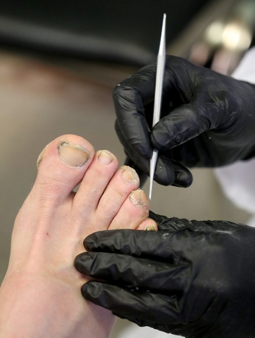 TREVOR HAGAN /  WINNIPEG FREE PRESS
Foot care nurse, Louie Jacinto examining a mans feet. End Homelessness Winnipeg and the Manitoba Financial Empowerment Network put on a homelessness expo at the Neeginan Centre, Saturday, May 26, 2018.