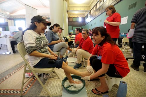 TREVOR HAGAN /  WINNIPEG FREE PRESS
Marjorie Moose has her feet washed and massaged by Isabel Colucci. End Homelessness Winnipeg and the Manitoba Financial Empowerment Network put on a homelessness expo at the Neeginan Centre, Saturday, May 26, 2018.