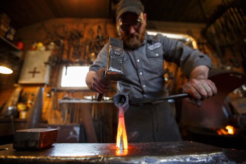 MIKE DEAL / WINNIPEG FREE PRESS
Matt Jenkins co-owner of Cloverdale Forge works on an axe head that will be on display at the Manitoba Museum in the newly renovated Nonsuch gallery.
180419 - Thursday, April 19, 2018.