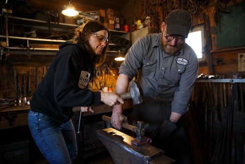 MIKE DEAL / WINNIPEG FREE PRESS
Partners Karen Rudolph and Matt Jenkins owners of Cloverdale Forge work on an axe head that will be on display at the Manitoba Museum in the newly renovated Nonsuch gallery.
180419 - Thursday, April 19, 2018.