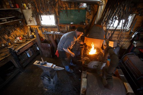 MIKE DEAL / WINNIPEG FREE PRESS
Matt Jenkins co-owner of Cloverdale Forge works on an axe head that will be on display at the Manitoba Museum in the newly renovated Nonsuch gallery.
180419 - Thursday, April 19, 2018.
