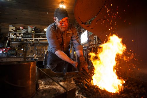 MIKE DEAL / WINNIPEG FREE PRESS
Matt Jenkins co-owner of Cloverdale Forge works on an axe head that will be on display at the Manitoba Museum in the newly renovated Nonsuch gallery.
180419 - Thursday, April 19, 2018.