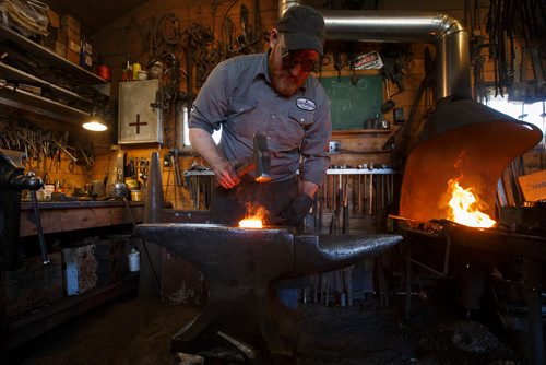 MIKE DEAL / WINNIPEG FREE PRESS
Matt Jenkins co-owner of Cloverdale Forge works on an axe head that will be on display at the Manitoba Museum in the newly renovated Nonsuch gallery.
180419 - Thursday, April 19, 2018.