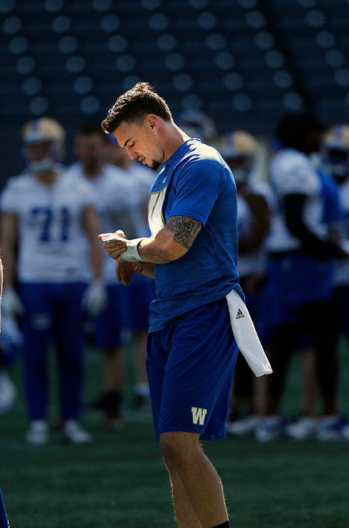 PHIL HOSSACK / WINNIPEG FREE PRESS - Bomber newcomer Bryan Bennett checks the plays on his write as he shadowed the QB's at a team workout Monday. Mike Sawatzsky story. - May 28, 2018