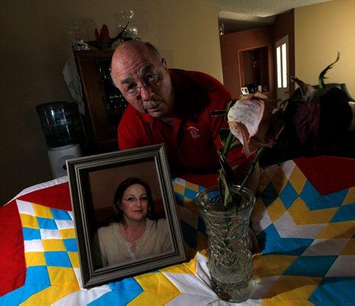 PHIL HOSSACK / WINNIPEG FREE PRESS -Kelly Gorzen poses on a Star blanket presented to his partner Tamy Boyce after her efforts as an EMO offecer with theLake Manitoba First Nation after the 2011 flood. Her portrait and two roses from her "Celebration of Life" adorn the blanket, Tammy died in April. See Alex Paul story.  - May 28, 2018