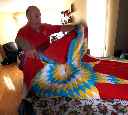 PHIL HOSSACK / WINNIPEG FREE PRESS -Kelly Gorzen spreads out a Star blanket presented to his partner Tamy Boyce after her efforts as an EMO offecer with theLake Manitoba First Nation after the 2011 flood. Tammy died in April. See Alex Paul story.  - May 28, 2018