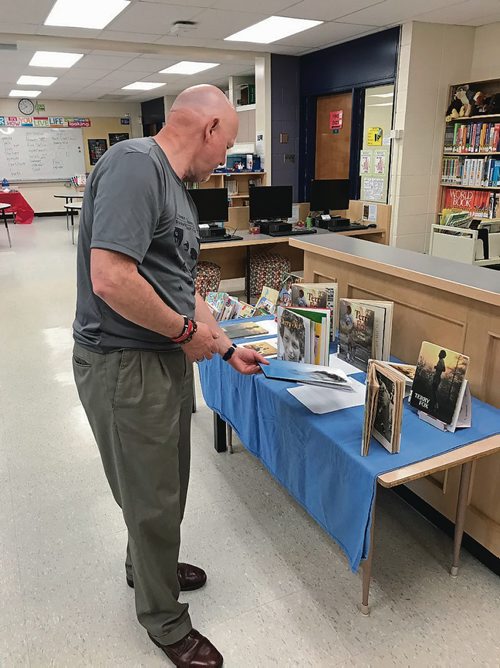 Canstar Community News Fred Fox looks over a table of books about his younger brother Terry in the Wayoata School library. Both Fred and Terry attended Wayoata School in the early 1960s. (SHELDON BIRNIE/CANSTAR/THE HERALD)