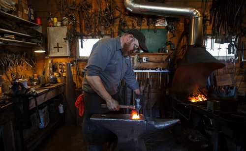 MIKE DEAL / WINNIPEG FREE PRESS
Matt Jenkins co-owner of Cloverdale Forge works on an axe head that will be on display at the Manitoba Museum in the newly renovated Nonsuch gallery.
180419 - Thursday, April 19, 2018.