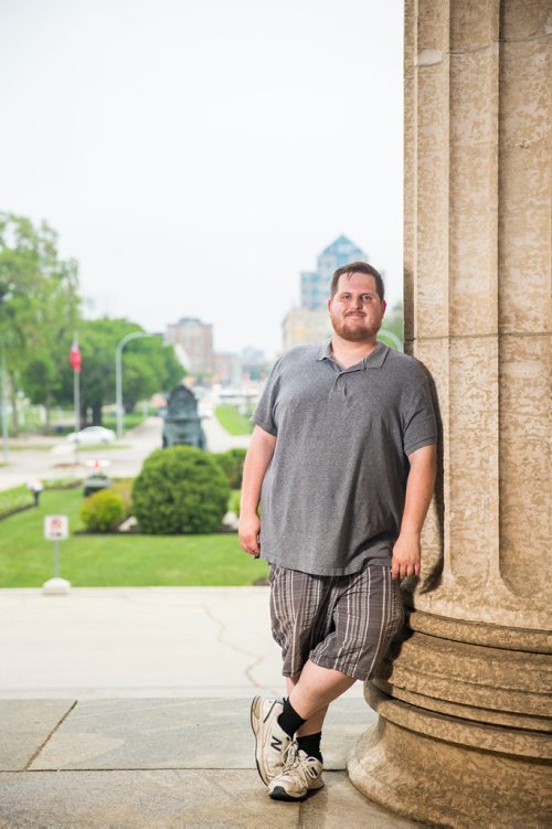 MIKAELA MACKENZIE / WINNIPEG FREE PRESS
Justin Luschinski, who is taking part in Pride this weekend, poses in front of the Manitoba Legislative Building in Winnipeg on Wednesday, May 30, 2018.  
Mikaela MacKenzie / Winnipeg Free Press 2018.